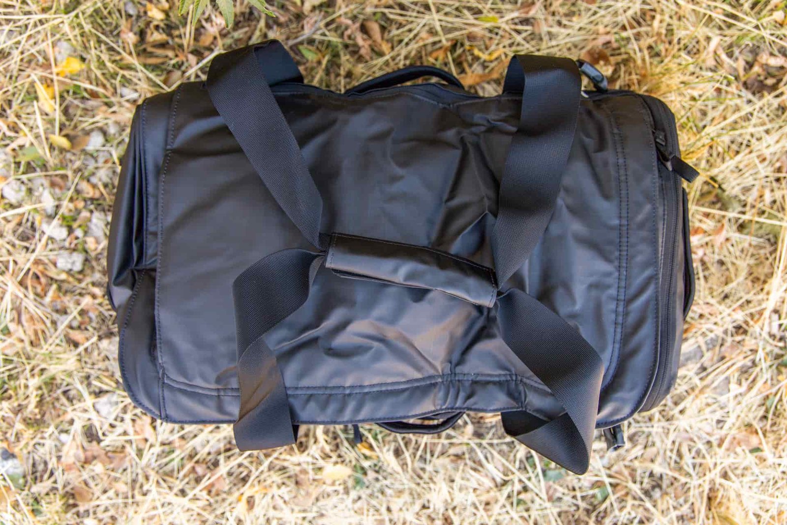 A top down view of the duffel with duffel straps lashed together with a Velcro wrap.