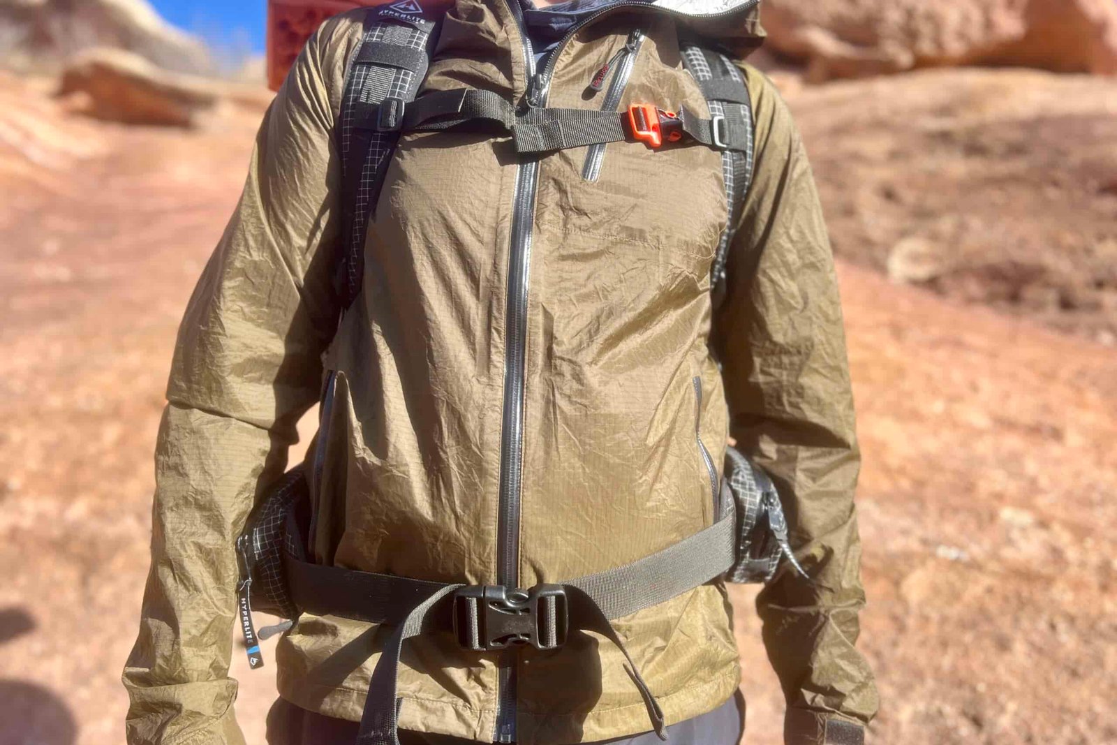 A torso shot of a hiker wearing the HMG Southwest 55 pack with a desert background.