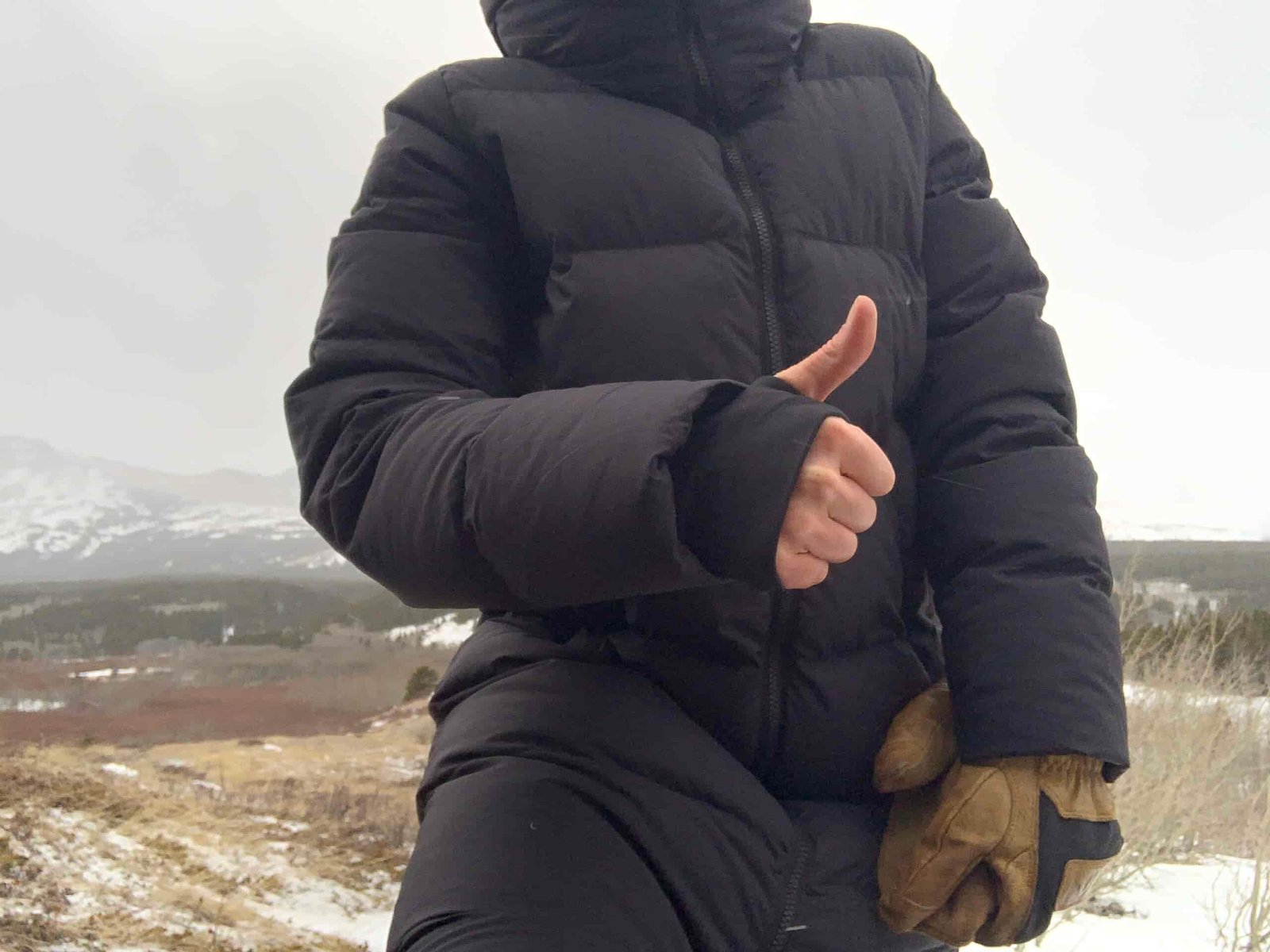 A woman's hand with the cuff and thumbhole used to seal out drafts through the arms of the outdoor research coze down parka.