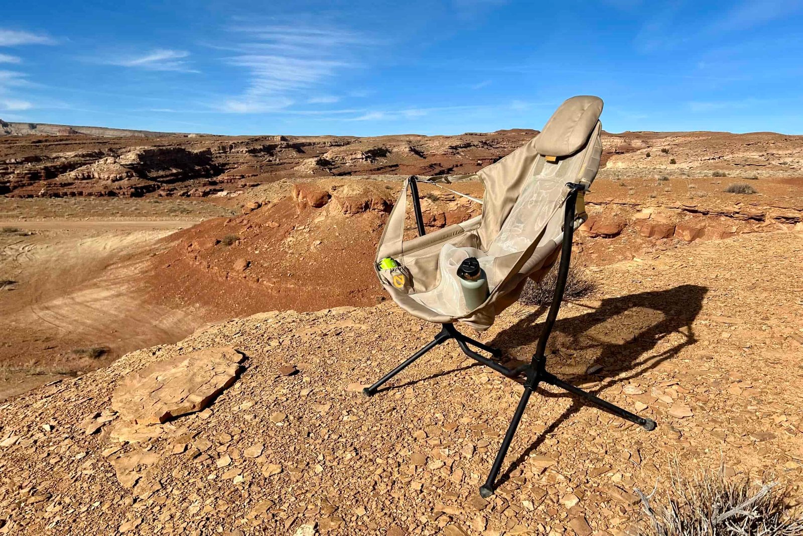 A camping chair in a sunny desert setting.
