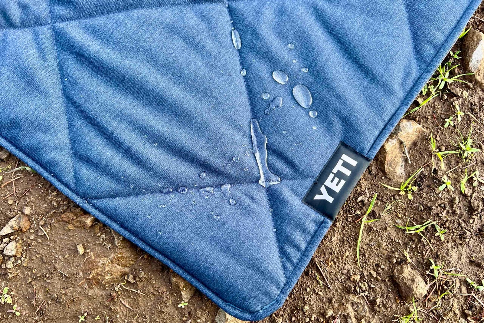 Water beads on the top insulated layer of the Yeti Lowlands Blanket