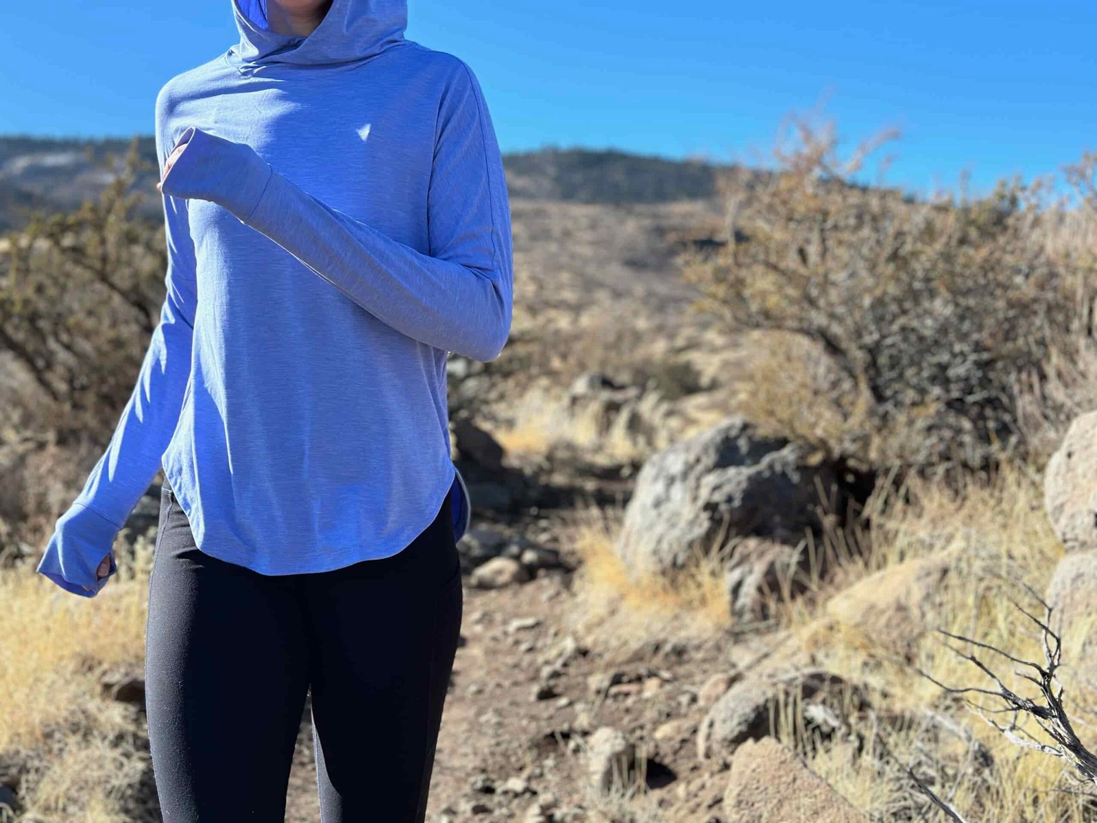 woman hiking in high desert with dog