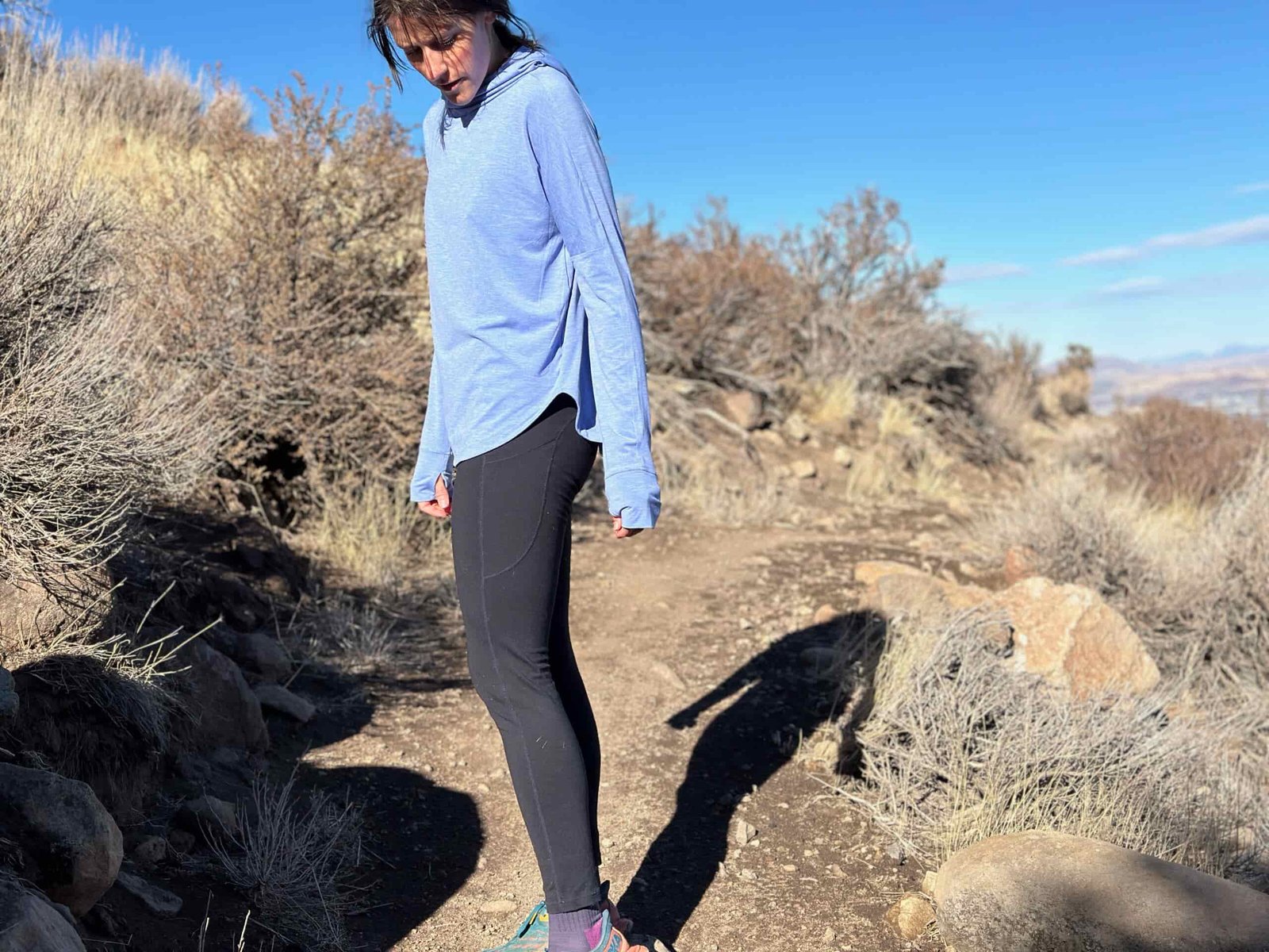 woman hiking in high desert with dog