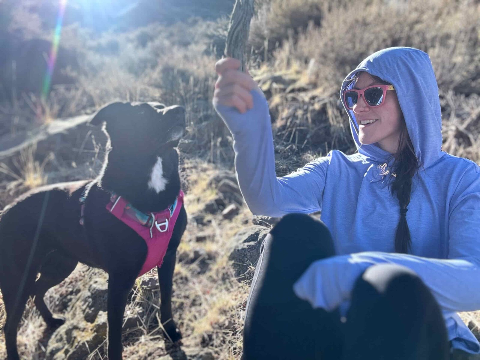 woman hiking in high desert with dog