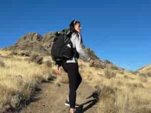 woman hiking with backpacking pack on through high desert