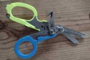 The Leatherman Raptor with blue and yellow handles and its tools deployed.