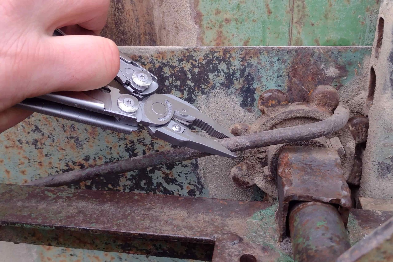 The Leatherman Surge gripping a farm wagon part.