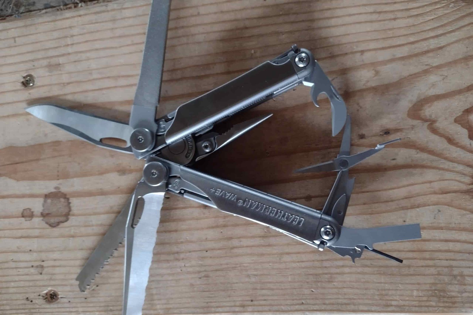 The Leatherman Wave+ resting on a board, with its tools deployed.