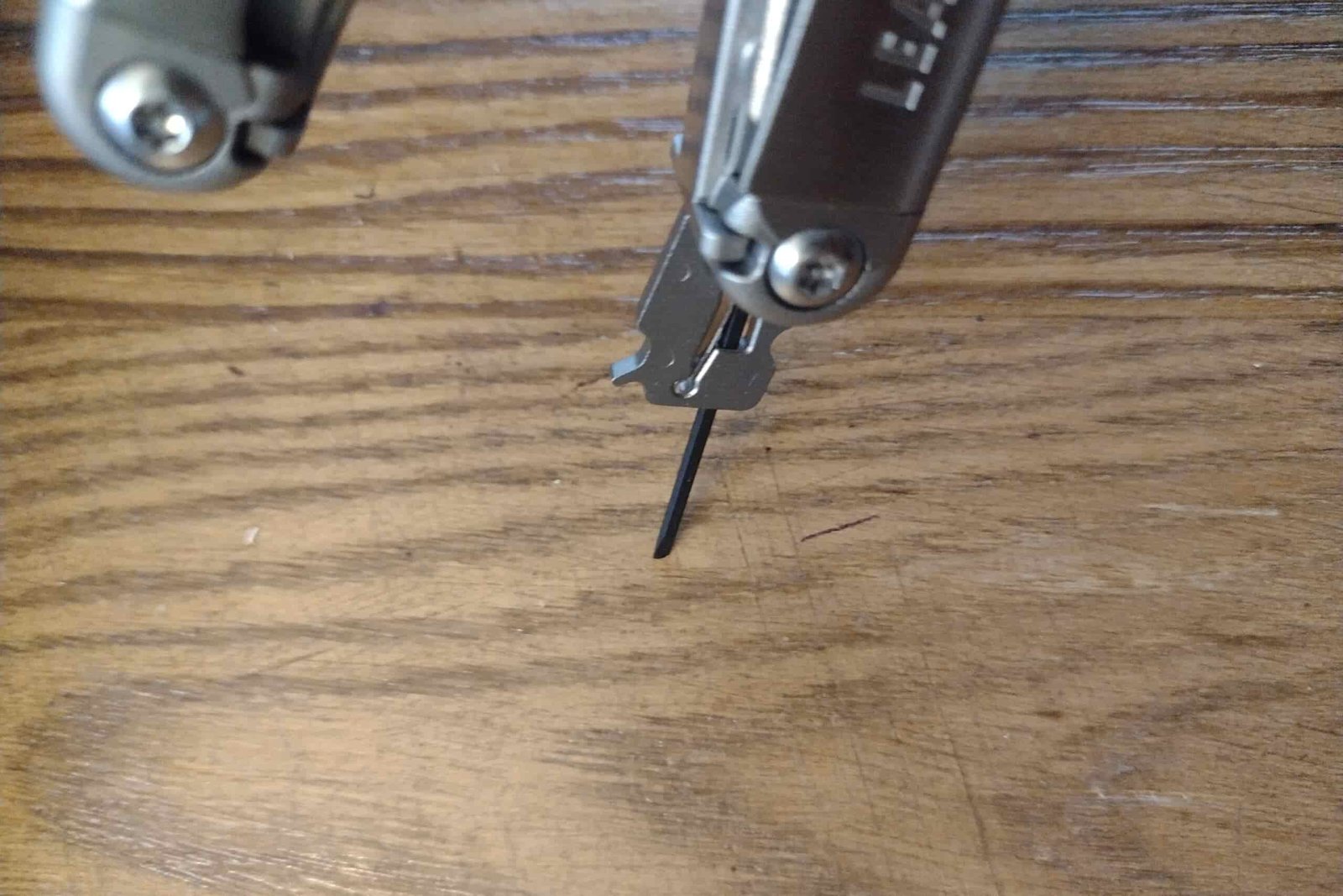 The Leatherman Wave+ with its awl extended into a board.