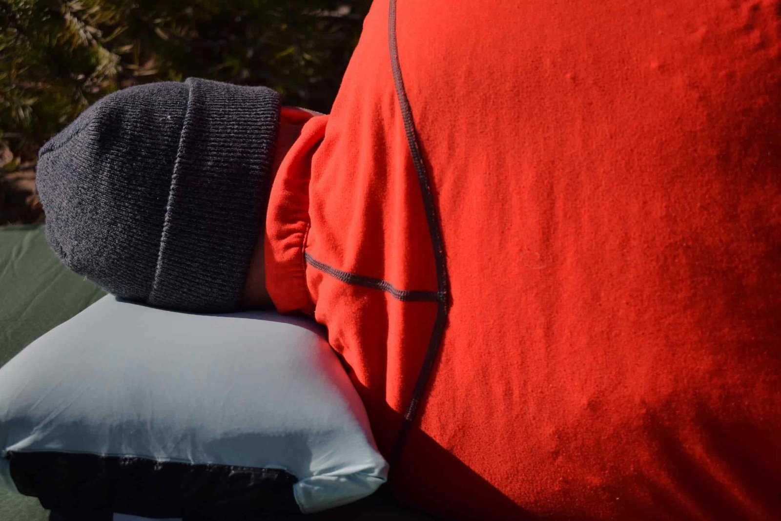 Close up of a side sleeper with his neck aligned laying on the NEMO Fillo