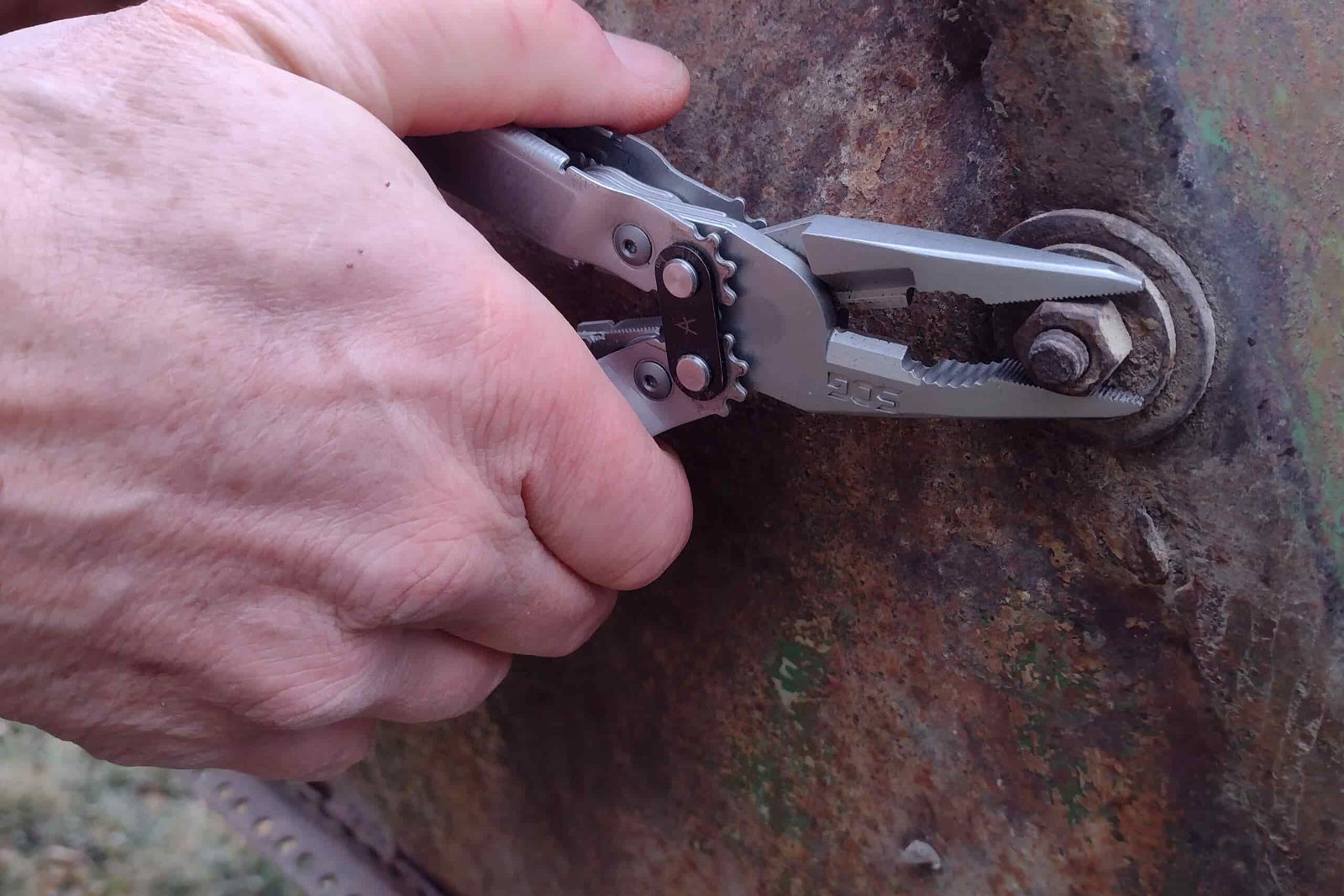 The SOG PowerAccess gripping a rusty nut.