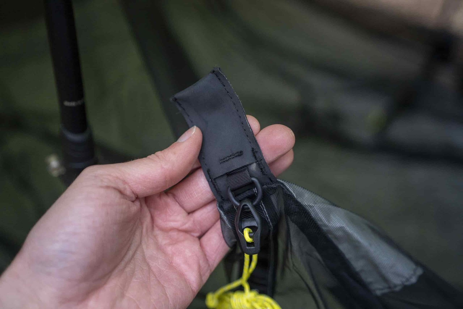 A hand holds a durable fabric pocket