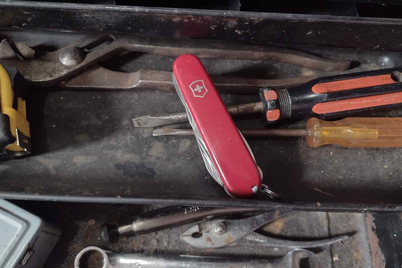 The Victorinox Huntsman in a toolbox with other tools.