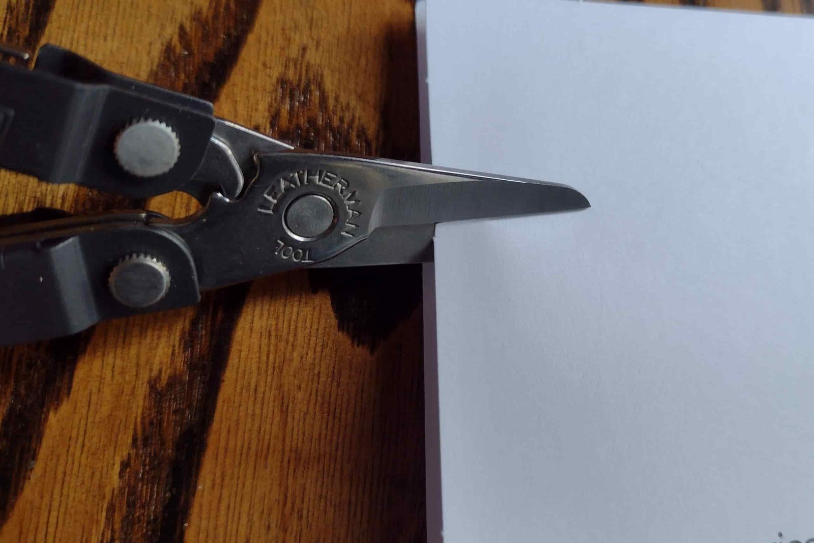 The Leatherman Micra cutting a sheet of paper.