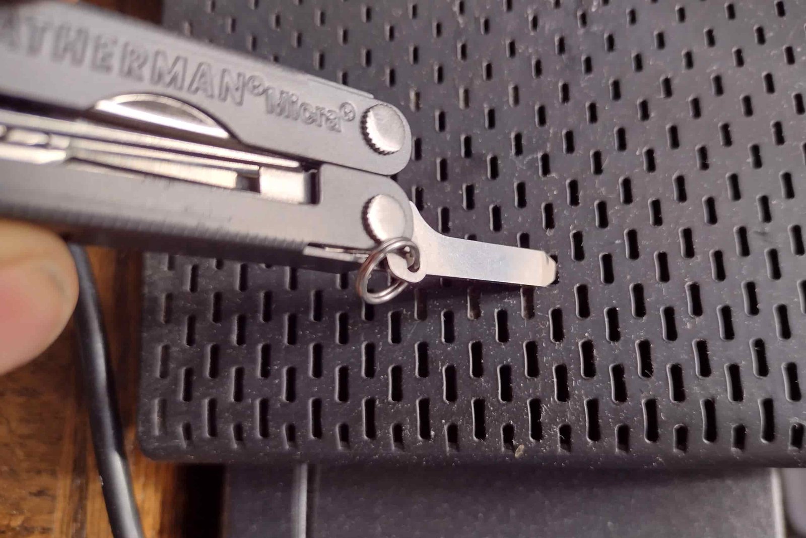 The Leatherman Micra using its standard screwdriver blade in a light repair.