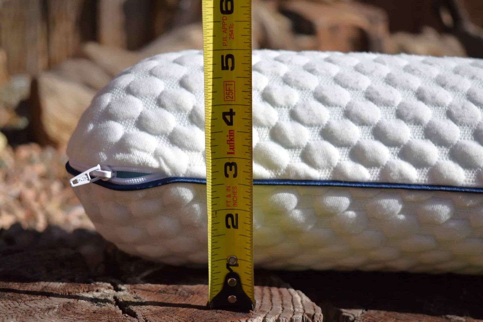A tape measure in front of the Weekender pillow shows a height of more than 5 inches