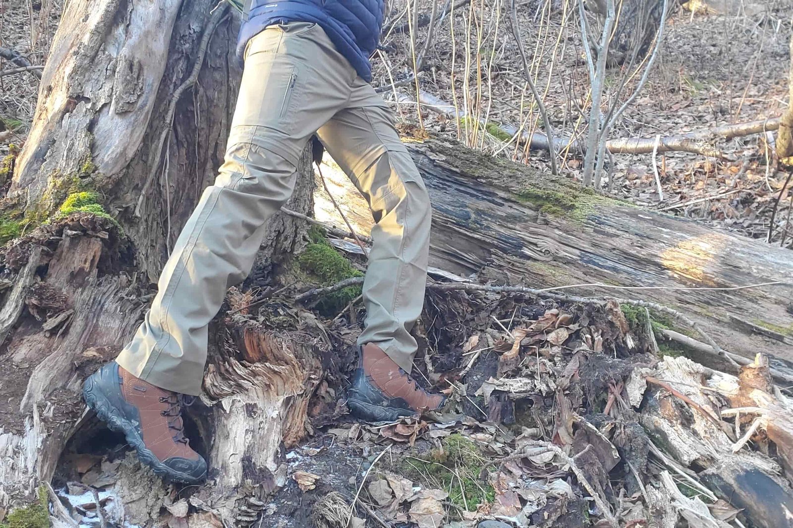 A waist down shot of a person hiking off trail.