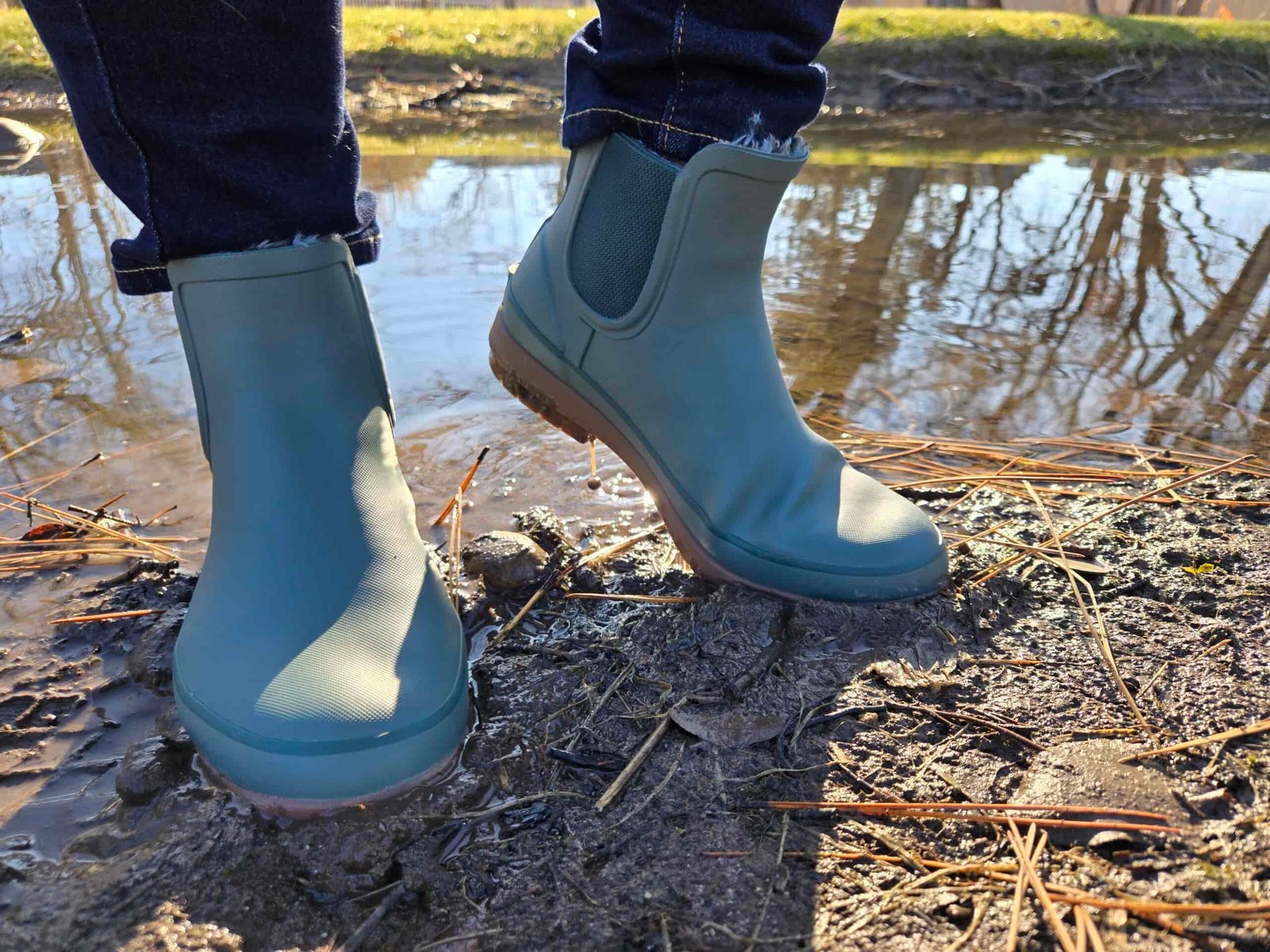 a women wearing bogs amanda chelsea next to a pond