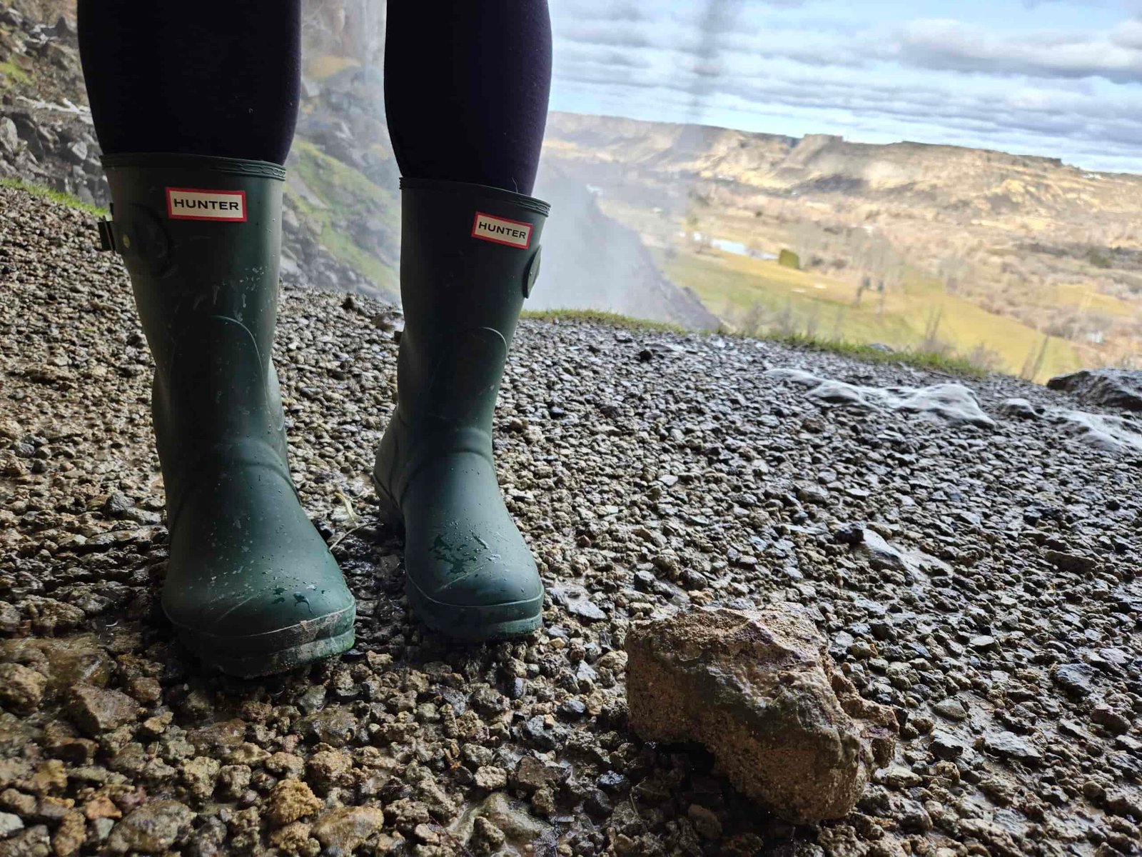 women in hunter original short boots next to a river