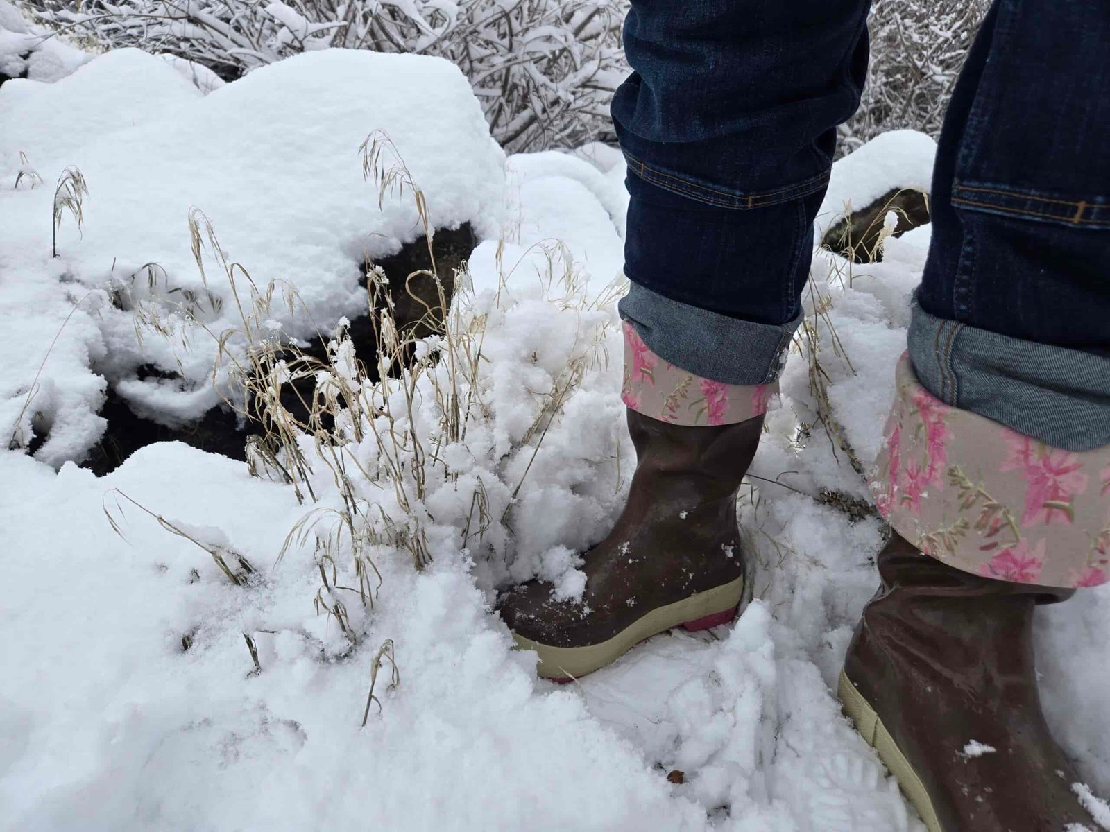 woman walking in some fresh snow in xtratuf work boots