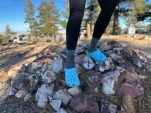 the Crocs Classic Clogs in blue traveling around a camp site in the high desert showing off its versatility and fit