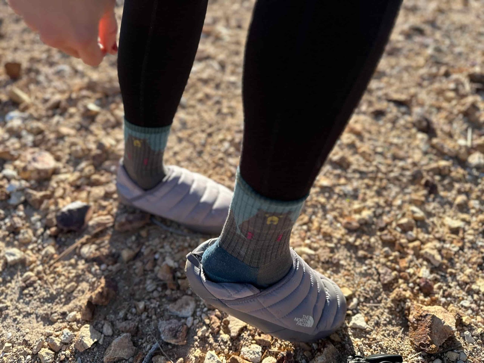 On rocky ground, woman shoes how the The North Face ThermoBall Traction Mules V heel can compact to make an easy slip-on style