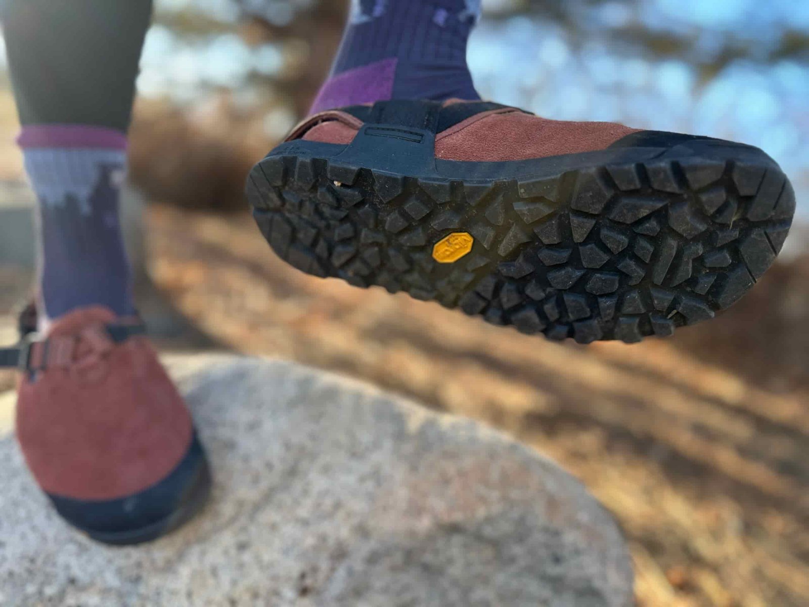 a woman shoes off the traction of the Bedrock Mountain Clog