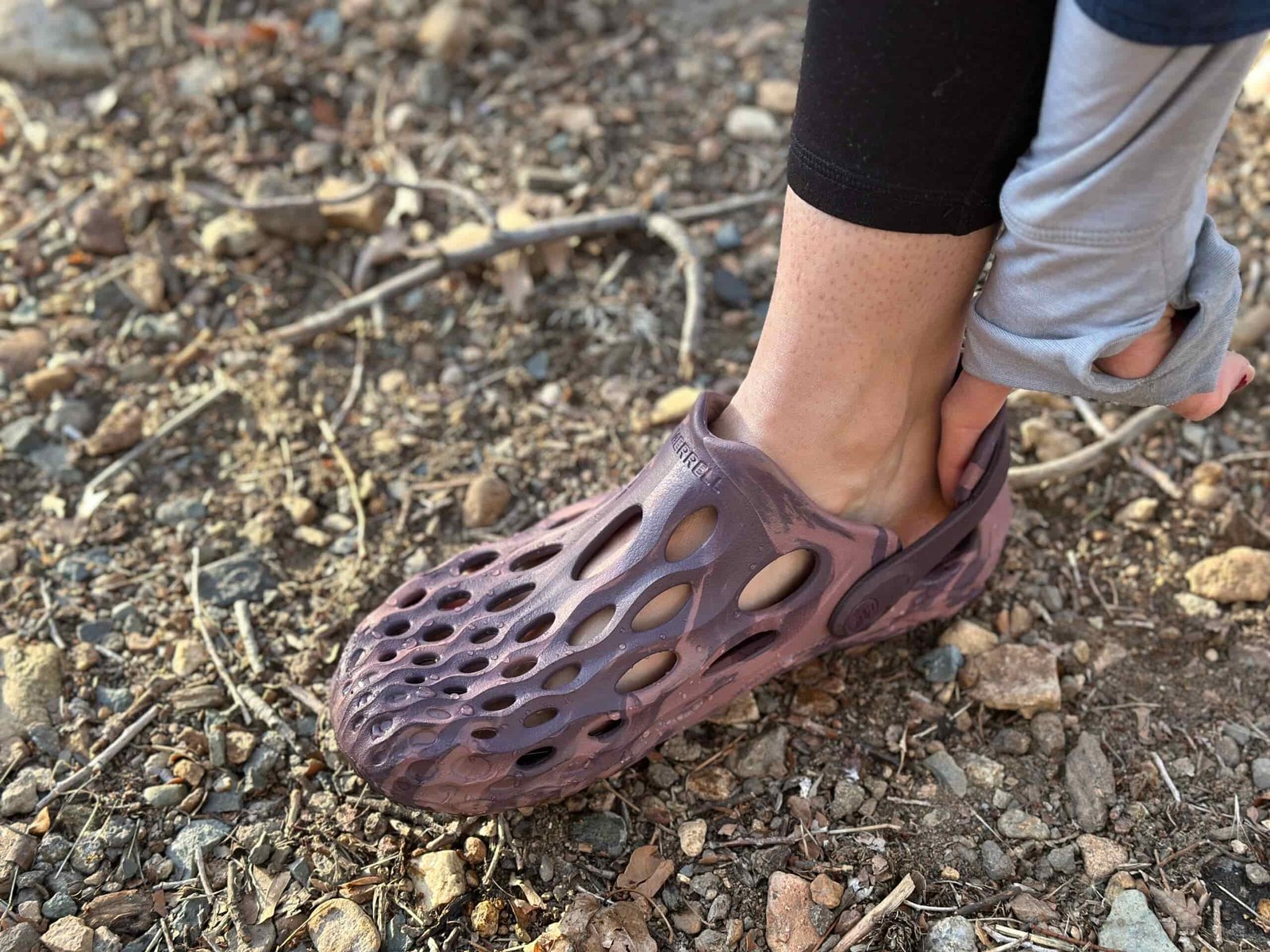 a woman wears Merrell Hydro Moc by a creek 