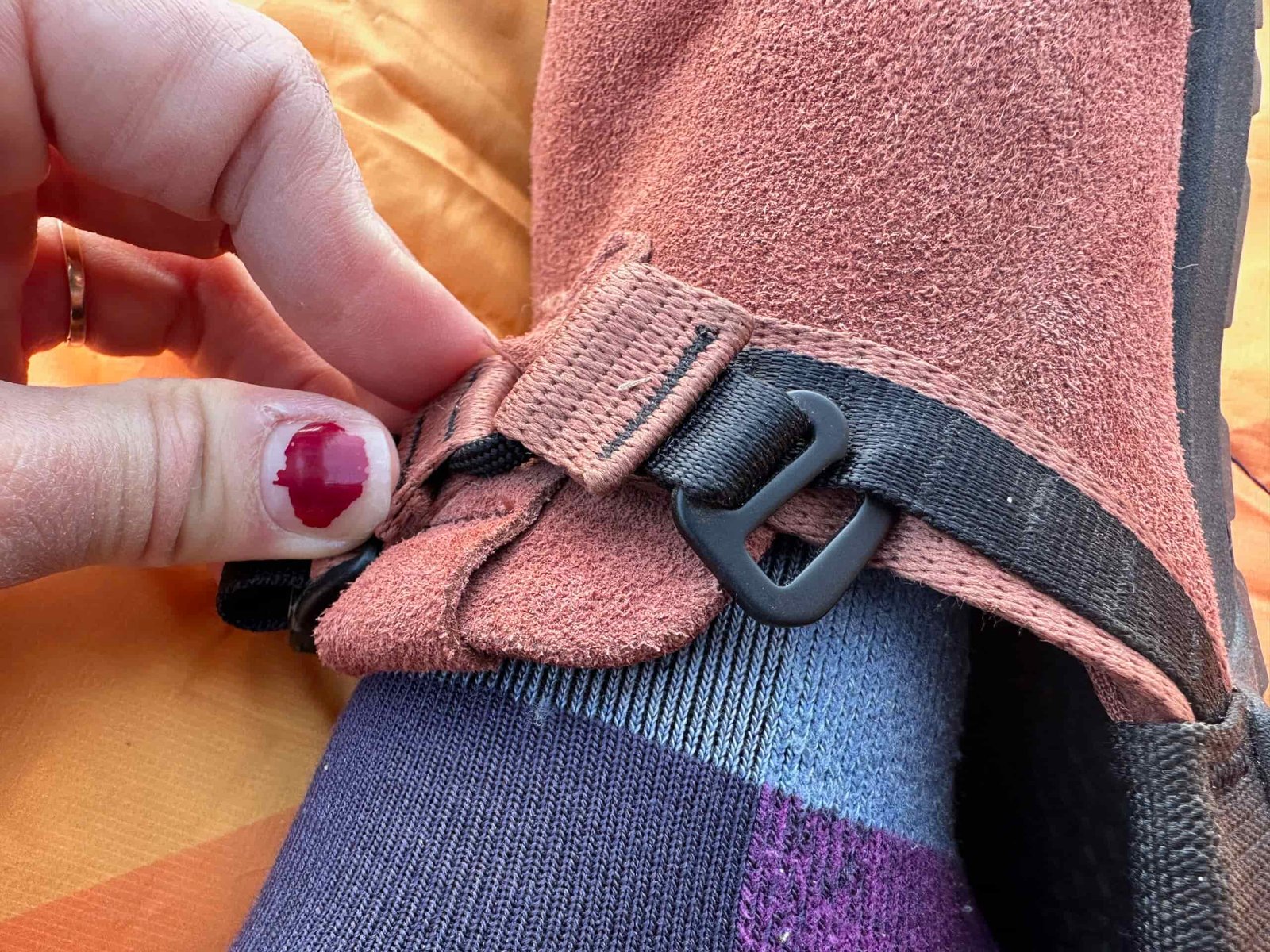a woman shows off the adjustable straps on the Bedrock Mountain Clog