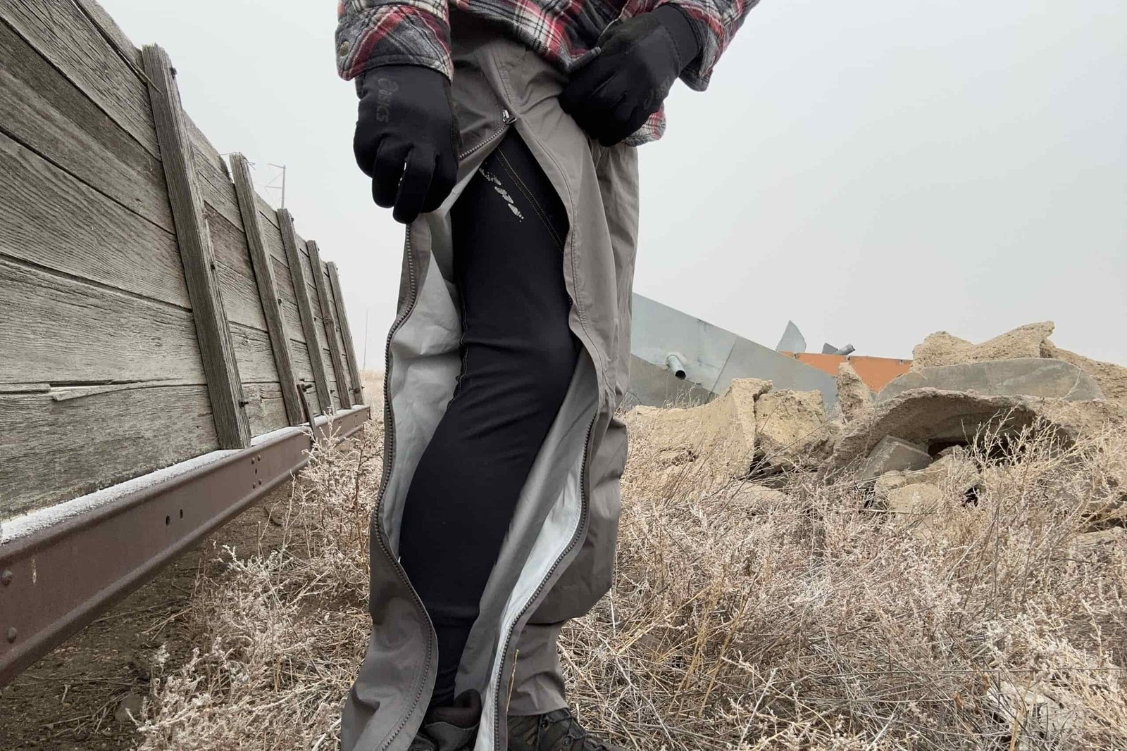 Closeup of someone wearing the REI Rainier rain pants, with the side zipper open.