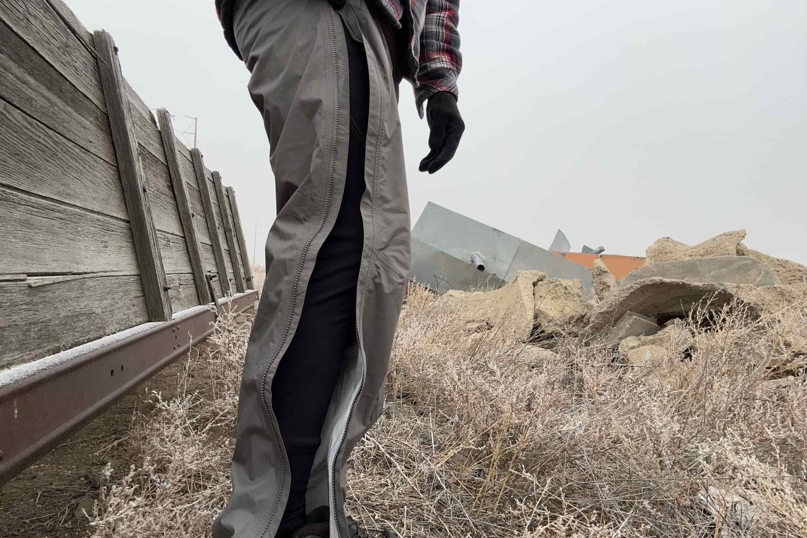 Closeup of someone wearing the REI Rainier rain pants, with the side zipper open.