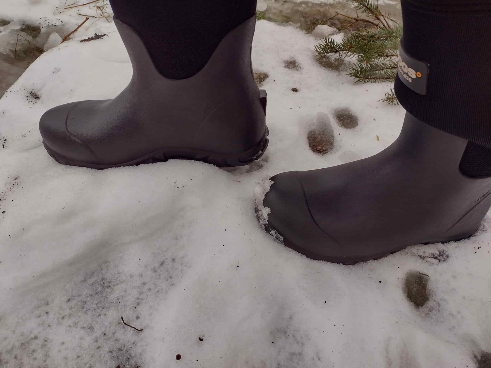 Ground level view of someone wearing the black Bogs Workman in the snow.