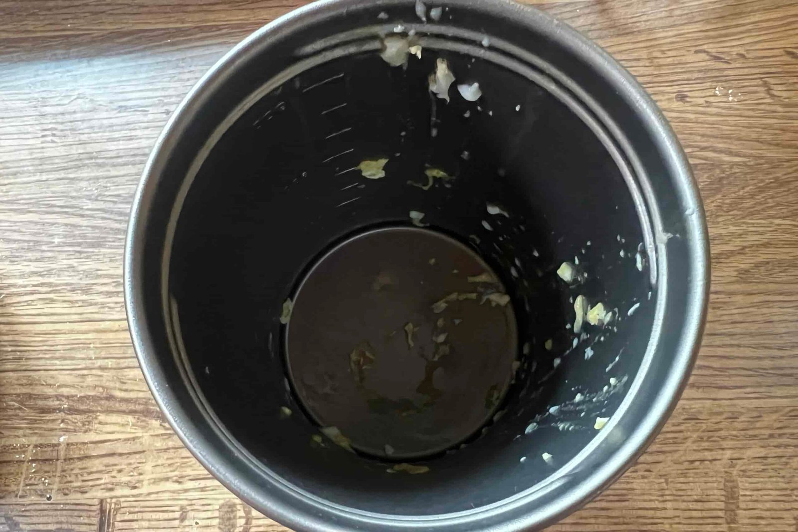 A top down view of a pot with pieces of egg in it.
