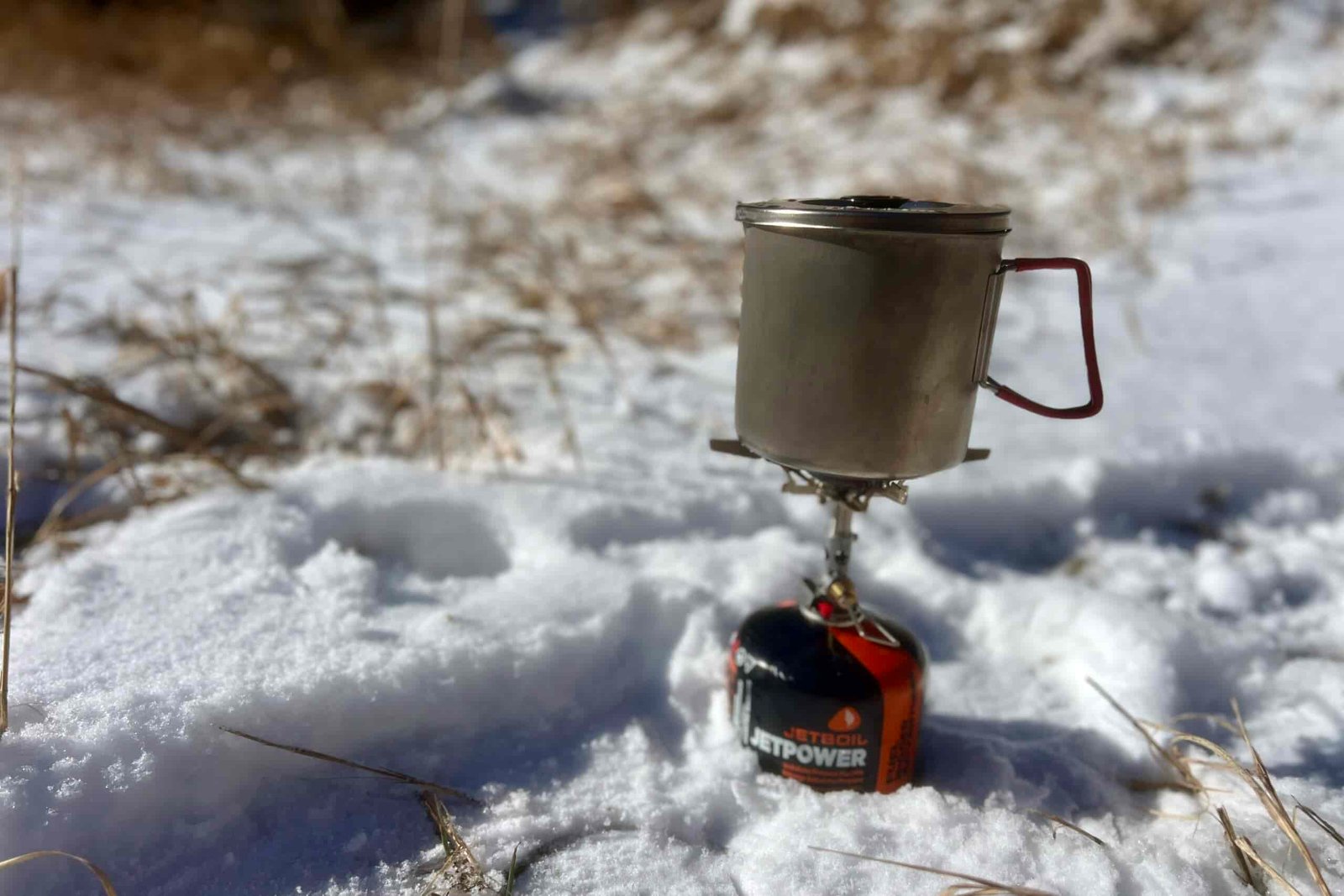 The evernew pasta pot sitting on a cook stove with a snowy background.