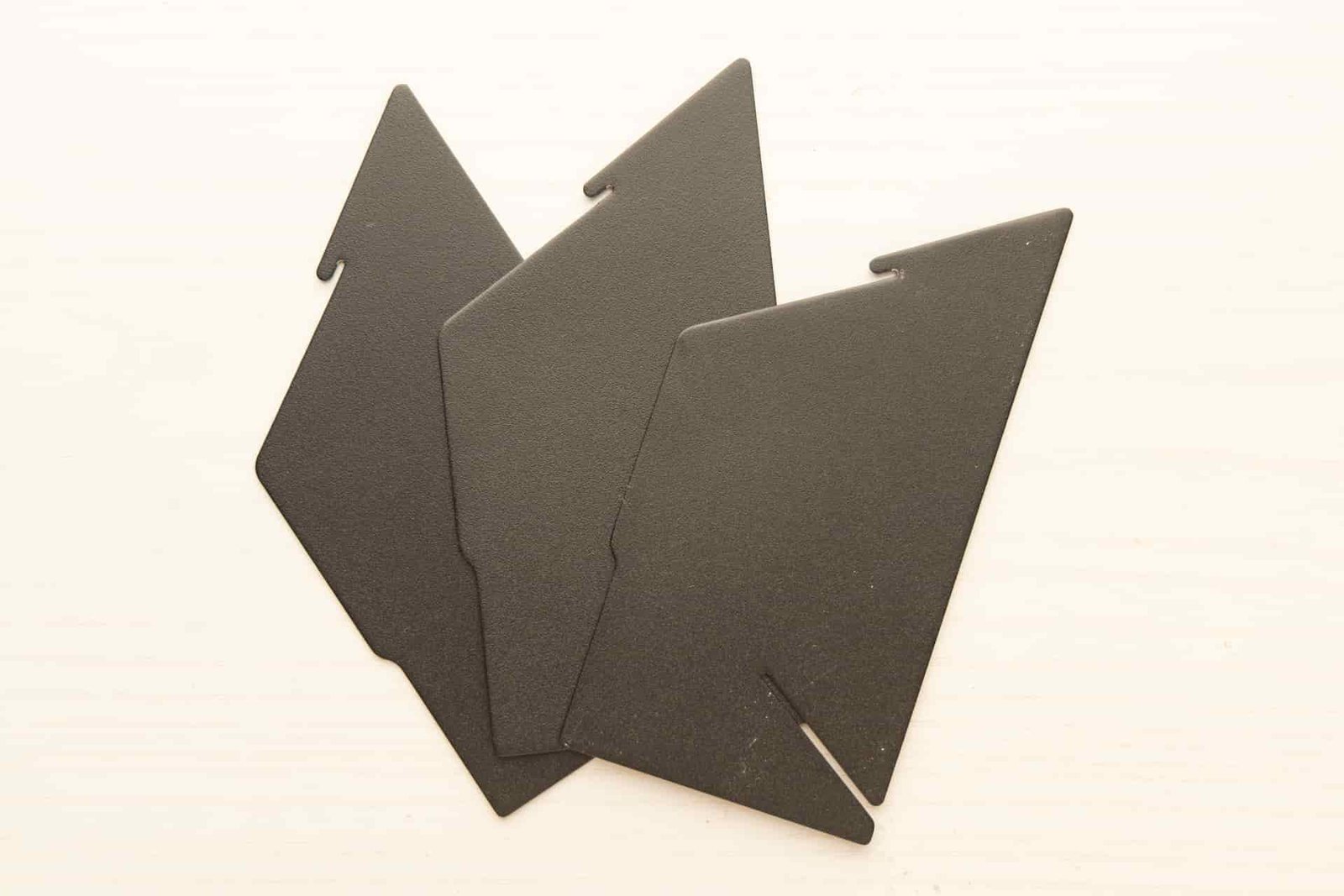 The MiiR Porigami unassembled: three identical metal pieces lay flat.