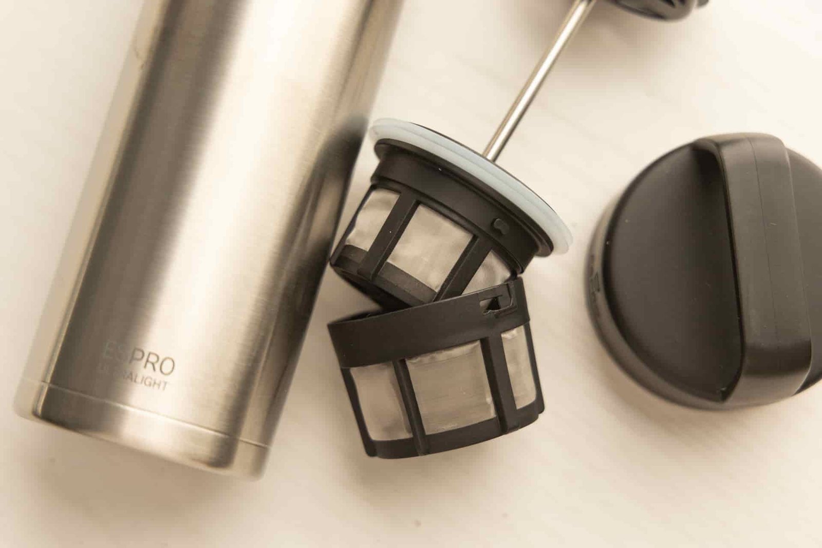 The ESPRO Filter and lid. The filter is disassembled into two parts.