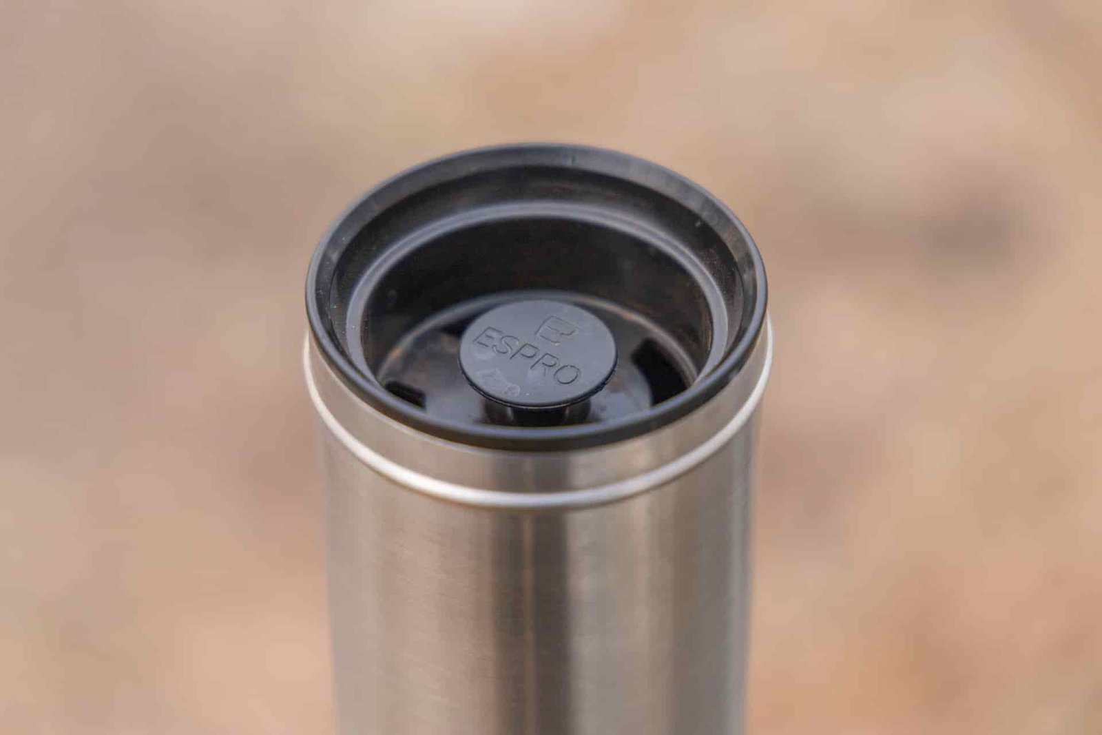 A view of the ESPRO interior lid and depressed plunger. There are holes around the lid for drinking.