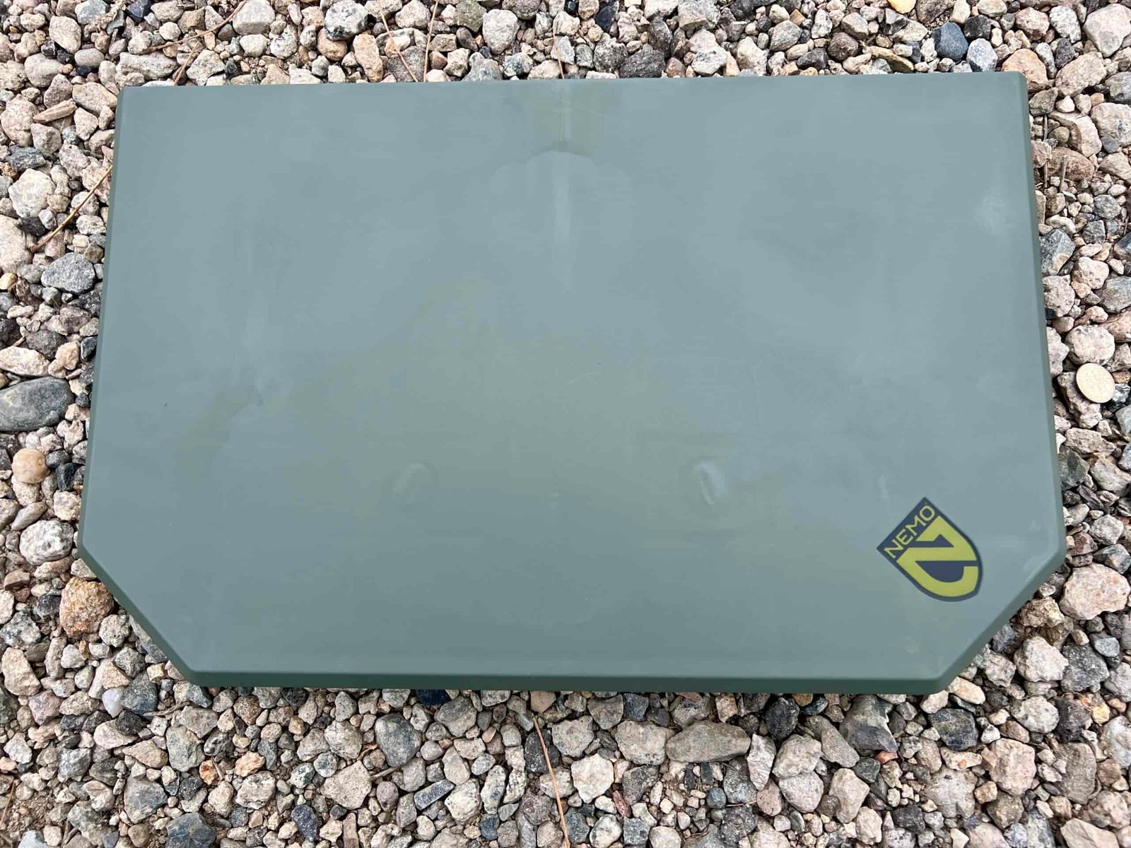 The NEMO Moonlander Dual-Height Table sits with its legs folded up on rocky ground.