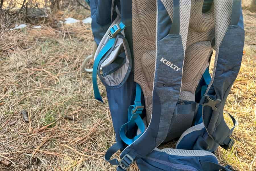 Back panel of the baby carrier showcasing padded straps and the Kelty logo for comfort and support.