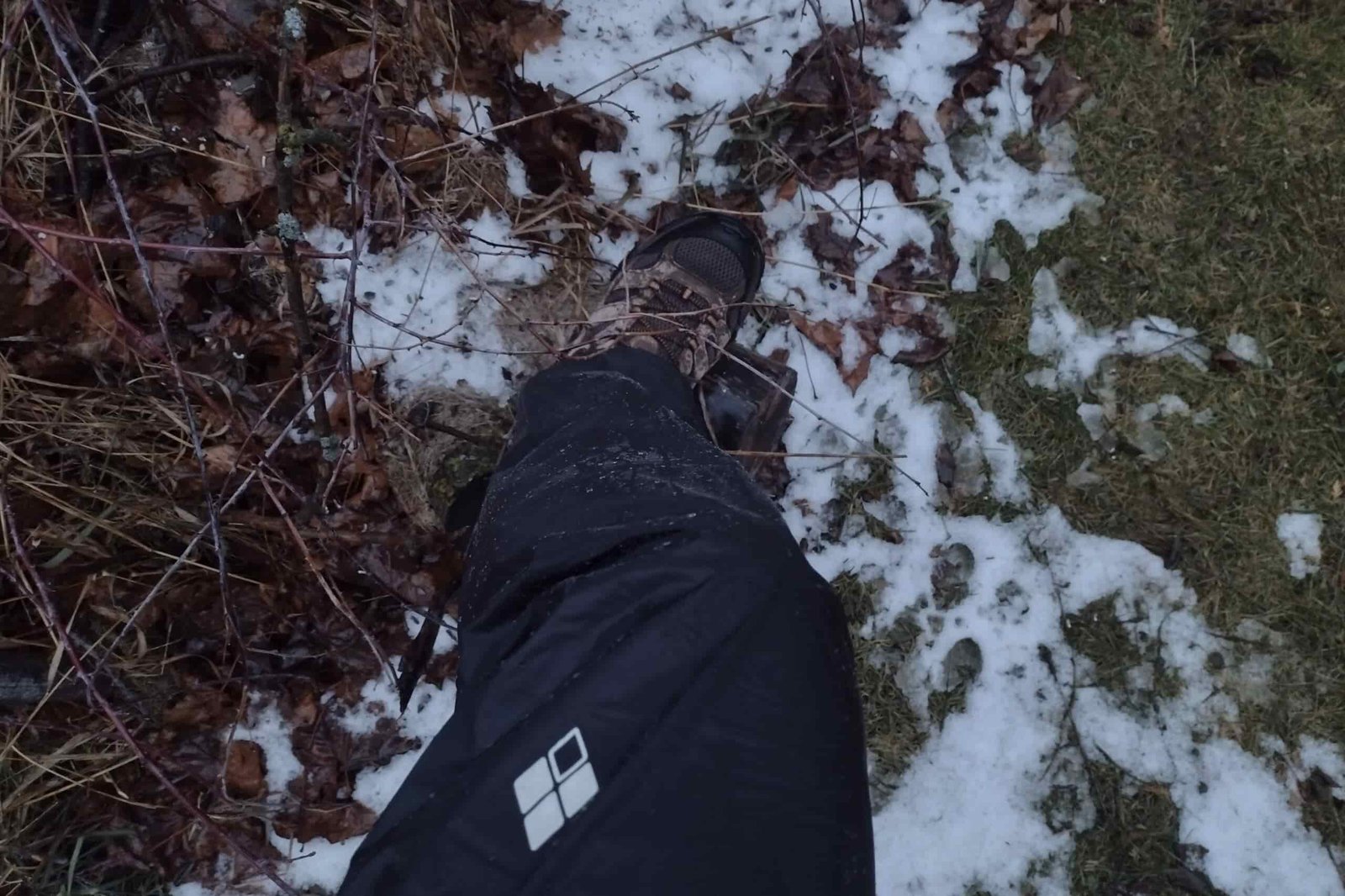 Closeup of a person wearing the Montbell Versalite rain pants.