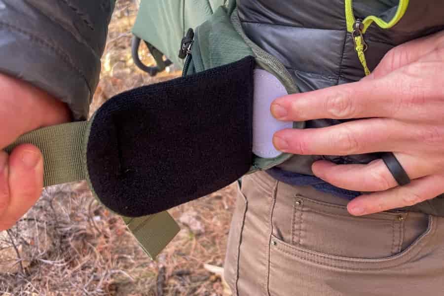 A close-up of the Velcro adjustment system on the Osprey Poco Premium’s hip belt, demonstrating its ease of use.