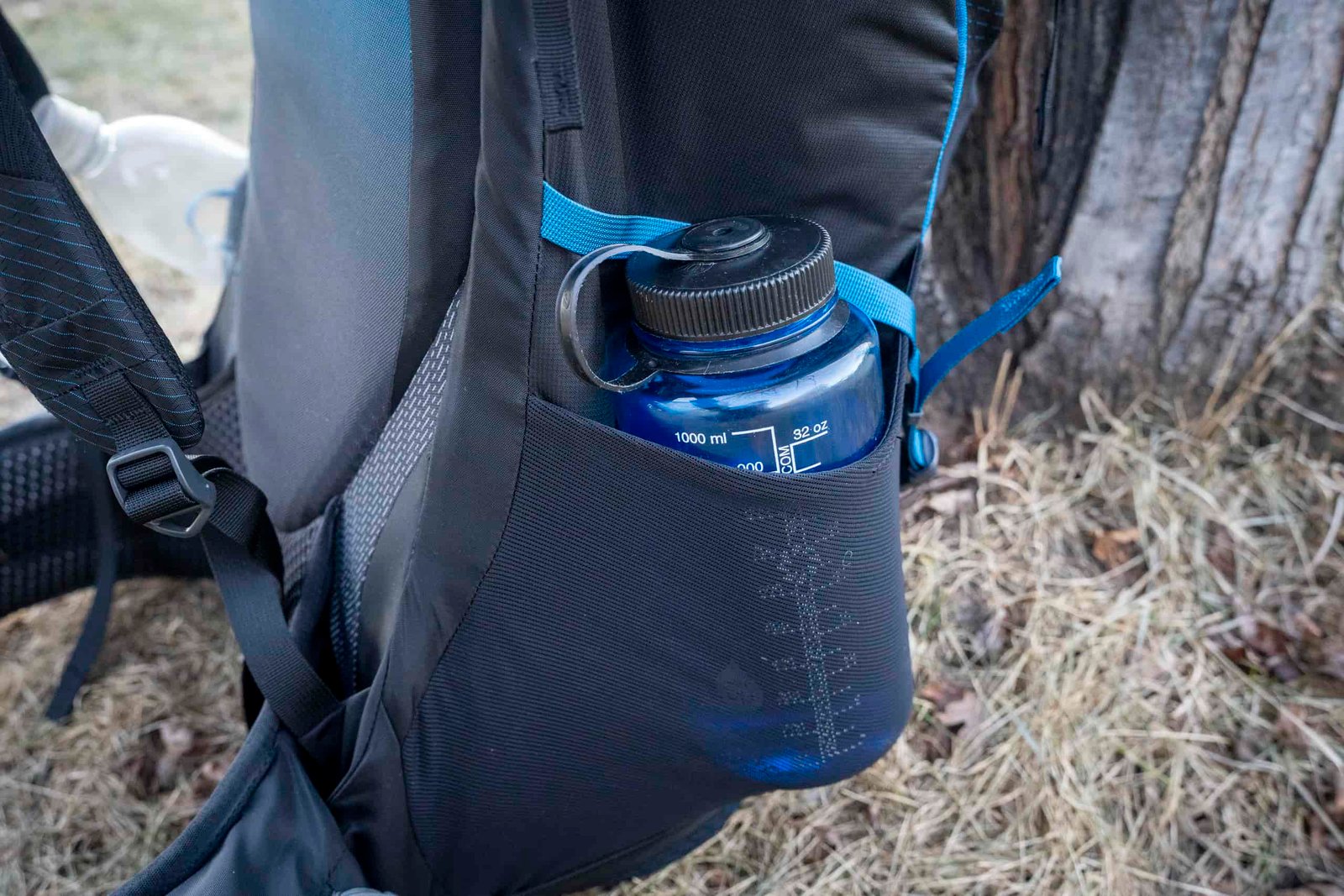 a water bottle in a side pocket of a backpack