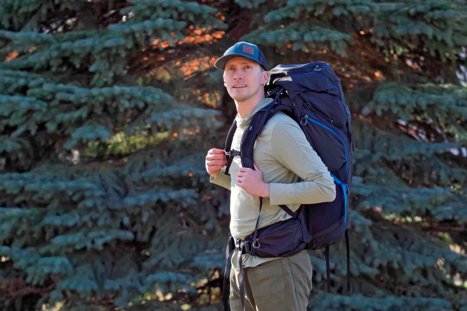 a man wearing a black and blue backpack