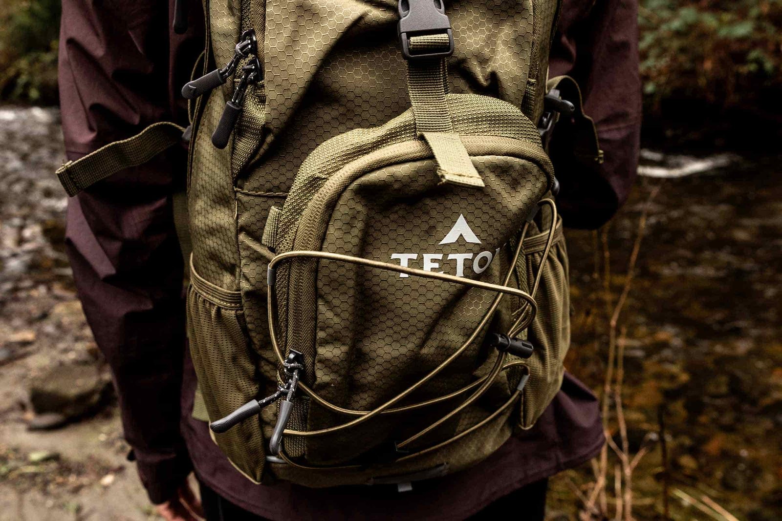 Details of TETON Sports Oasis 18L Hydration Pack - a person wearing the pack looking away