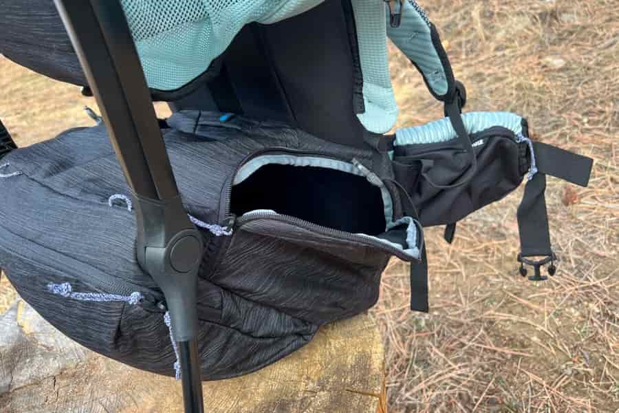 Another close-up of the Thule Sapling's lower storage compartment and zippered side access, emphasizing its organizational features.