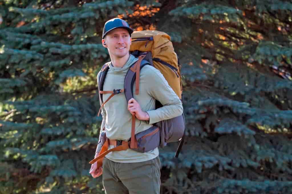 man wearing tan backpack