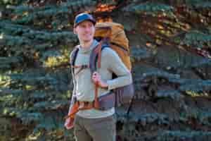 man wearing tan backpack