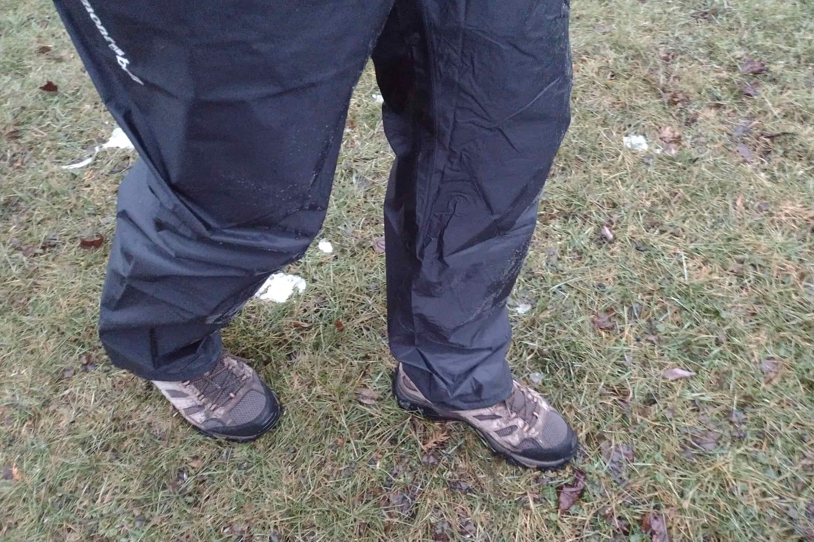 Closeup of a person wearing the Montbell Versalite rain pants.