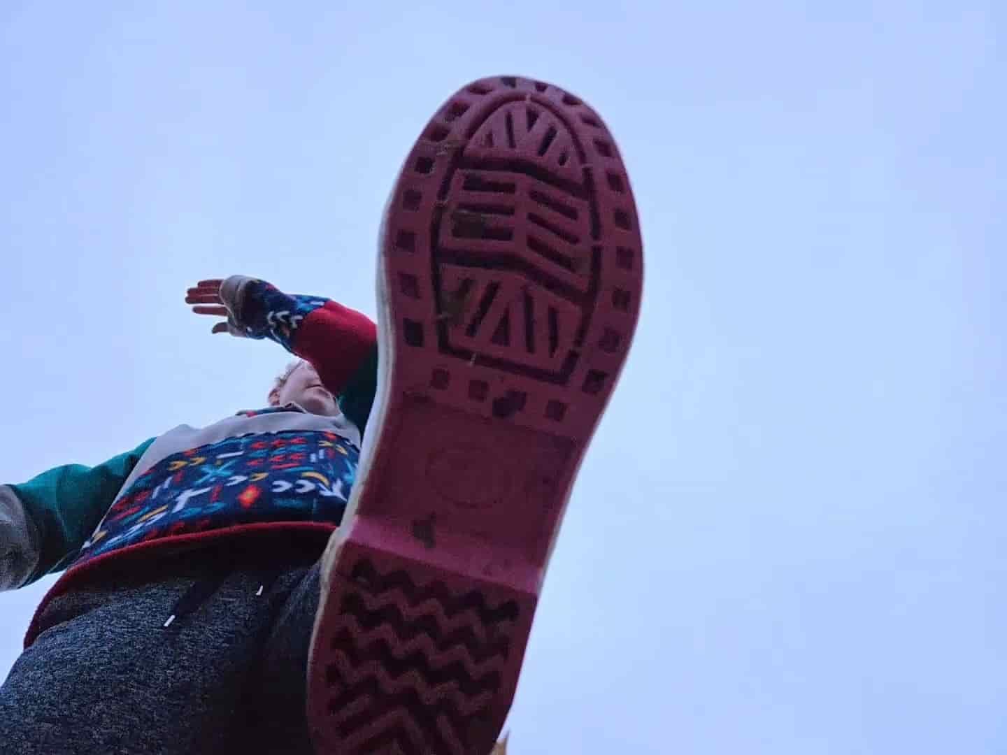 Looking up at the tread of the Xtratuf Legacy 15" rain boot. The outsole is pink.