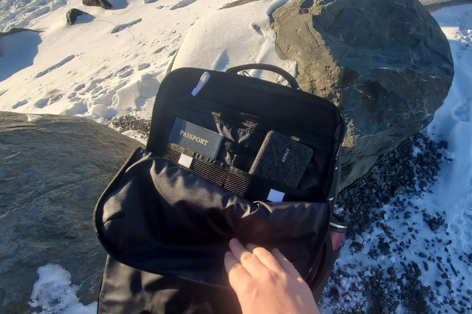 A closeup of the exterior pocket of a backpack showing organized items.